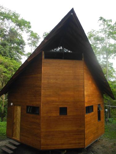 a large wooden house with a gambrel roof at Mogambo Ecolodge in Viotá