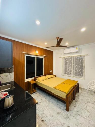 a bedroom with a bed and a television in a room at M M Residency in Cochin