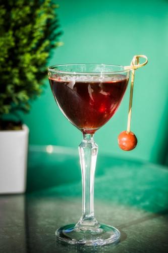 a drink in a glass sitting on a table at Altis Avenida Hotel in Lisbon