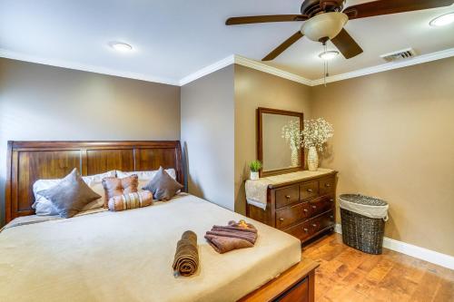 a bedroom with a bed with a ceiling fan and a dresser at Private Hot Tub on 10 Acres Cozy Catskill Getaway in Catskill