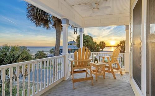 a porch with chairs and a view of the ocean at Sea of Cedar Key in Cedar Key