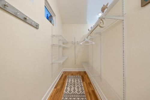 a hallway with stairs and a rug on the floor at Sea of Cedar Key in Cedar Key