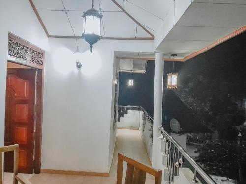 a hallway of a house with a staircase and a ceiling at Ocean Pearl Villa - Talalla in Matara