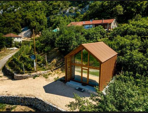 a small wooden house sitting on top of a hill at Ostrog Wood House in Železnička Stanica Dabovići