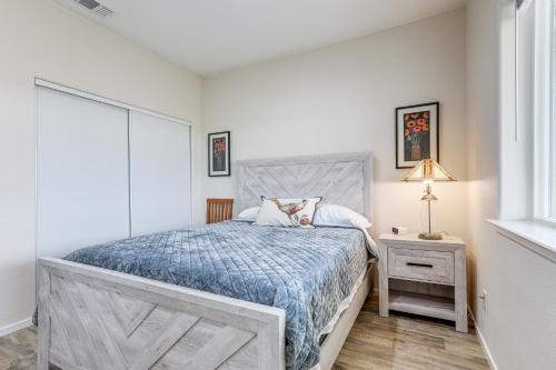 a bedroom with a bed with a blue comforter at On-Site Winery Rural Plymouth Getaway! in Plymouth