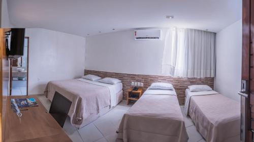 Ένα ή περισσότερα κρεβάτια σε δωμάτιο στο Hotel Costa do Atlântico