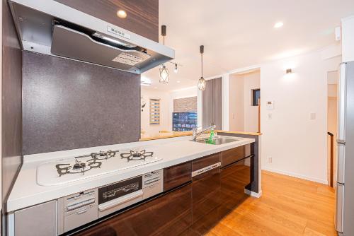 a kitchen with a sink and a stove at Arashi hotel 嵐ホテル in Tokyo