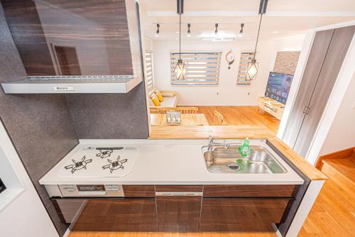 a kitchen with a sink and a stove at Arashi hotel 嵐ホテル in Tokyo