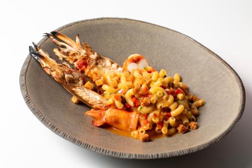 a plate of food with seafood and beans and corn at Altis Avenida Hotel in Lisbon