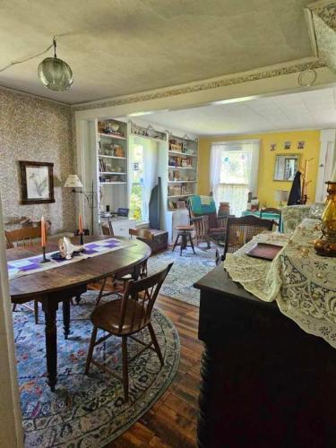 a living room with a large table and chairs at Perry Shore Road Cottage in Perry