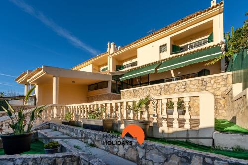 a house with a balcony with an orange arrow pointing to the house at #257 Villa Sun & Sea by Home Holidays in Albufeira