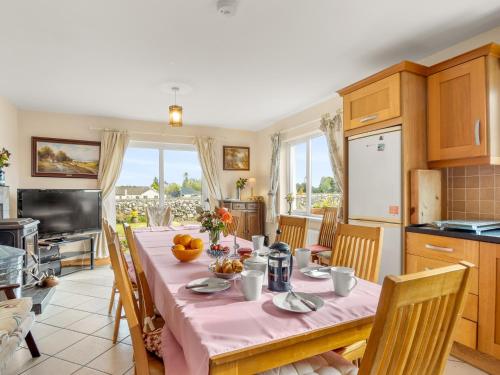 a kitchen and dining room with a table and chairs at Lough Mask Fishing Lodge in Ballinrobe