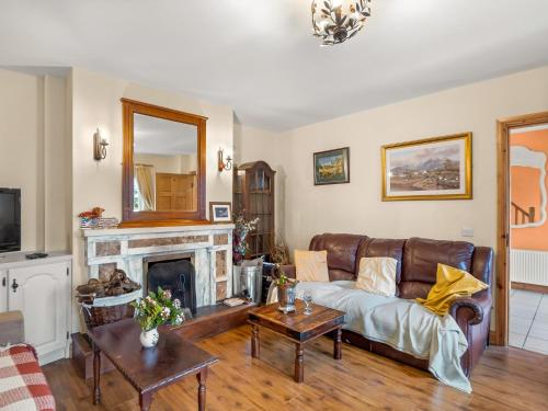 a living room with a couch and a fireplace at Lough Mask Fishing Lodge in Ballinrobe