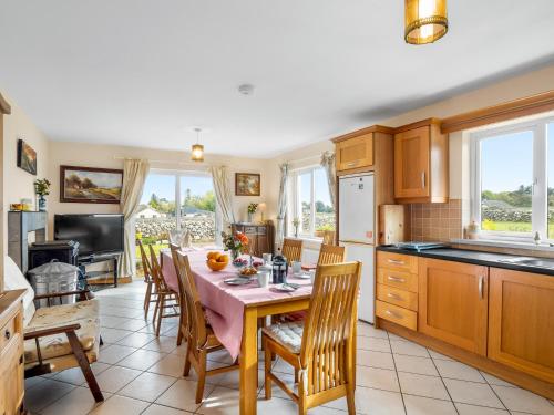 a kitchen with a table and some chairs and a kitchen with a tableablish at Lough Mask Fishing Lodge in Ballinrobe