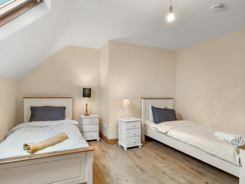 a bedroom with two beds and two night stands at Lough Mask Fishing Lodge in Ballinrobe