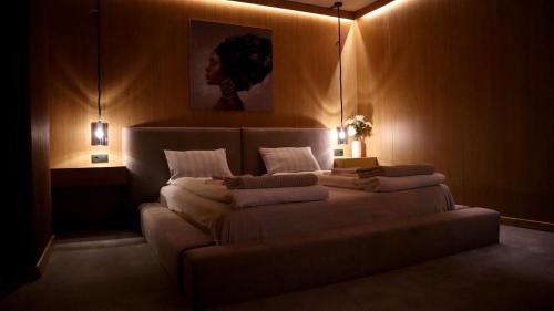 a bedroom with a large bed with lights on it at R34 Boutique Guest House in Veliko Tŭrnovo
