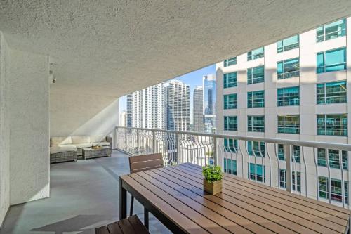 a balcony with a wooden table on top of a building at Waterfront and City Lights 1-BR With Free Parking in Miami