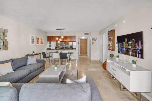 a living room with a couch and a table at Waterfront and City Lights 1-BR With Free Parking in Miami