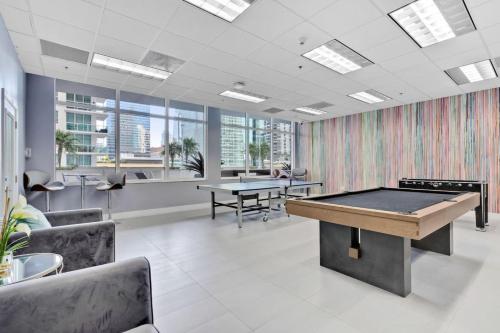 an office with a pool table and two tables at Waterfront and City Lights 1-BR With Free Parking in Miami