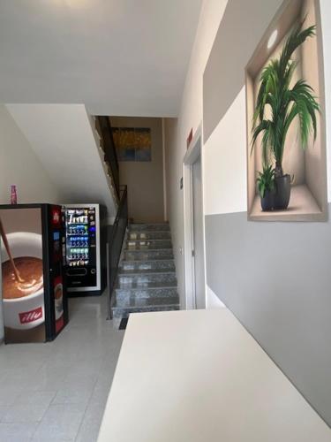 a hallway with a staircase and a vending machine in a building at Il mulino foresteria in Parona