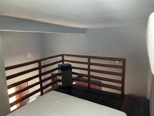 a bedroom with a bed and a wooden railing at Pousada Califa Taíba in São Gonçalo do Amarante