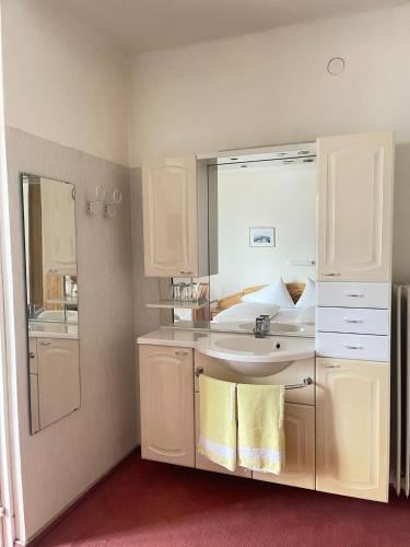 a bathroom with a sink and a mirror at Brunnhof Gastein in Bad Hofgastein