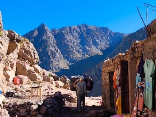 a man standing on a path in the mountains at Atlas Pearl in Aguersioual