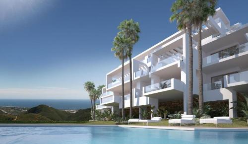 a large white building with palm trees and a swimming pool at Extra large Luxury property with Spa, 3 min to Marbella city center in Málaga