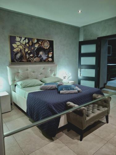 a bedroom with a bed with a blue comforter at Matilde Valletta Suites in Valletta