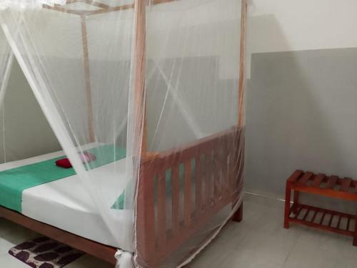 a bed with a canopy in a room at Black Panther Yala in Tissamaharama