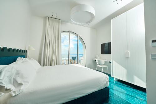 Un ou plusieurs lits dans un hébergement de l'établissement CALEA Boutique Hotel