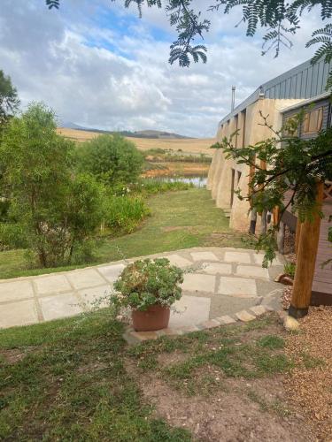 a walkway next to a building with a potted plant at The Country Cabin in Caledon