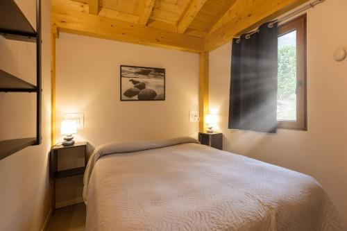Ένα ή περισσότερα κρεβάτια σε δωμάτιο στο Camping Camplani
