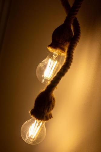 a close up of a light bulb hanging from a wire at Camping Camplani in Zone
