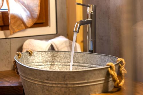a water fountain in a metal bucket on a table at Camping Camplani in Zone