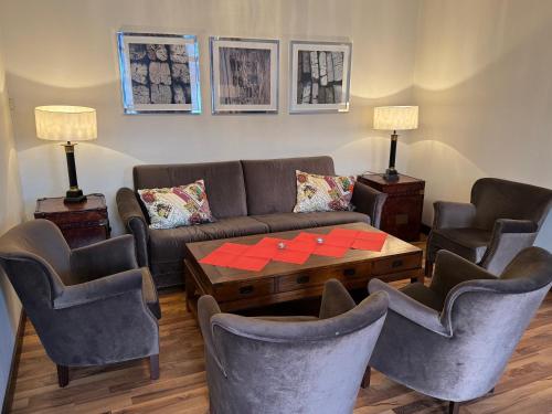 a living room with a couch and chairs and a table at Park Hotel Vossevangen in Vossevangen