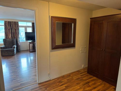 an empty living room with a mirror and a door at Park Hotel Vossevangen in Vossevangen
