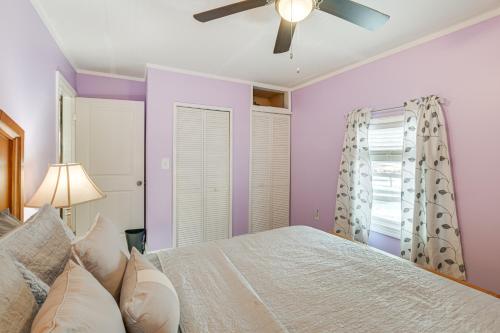 a bedroom with a white bed and a ceiling fan at Close to Dtwn Bangor Inviting Maine Home in Veazie