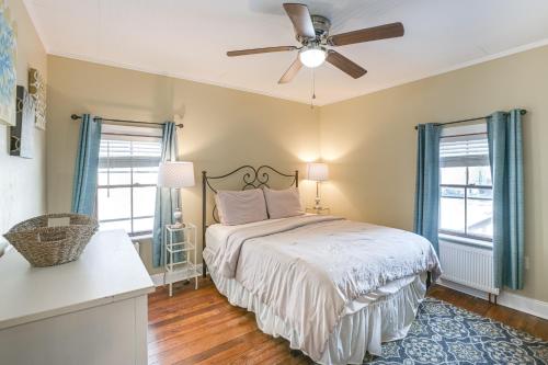 a bedroom with a bed and a ceiling fan at Close to Dtwn Bangor Inviting Maine Home in Veazie