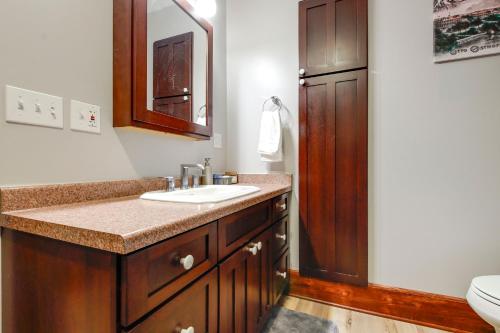 a bathroom with a sink and a toilet at 3 Mi to Road America Spacious Elkhart Lake Home! in Elkhart Lake