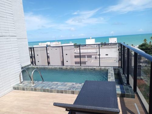 a swimming pool on the balcony of a building at 004 Suite - Banheira de imersão - PRAIA -Temp Ambiente in João Pessoa