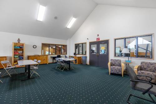 a waiting room with chairs and tables in a room at The Lodges at Breezy Point in Breezy Point