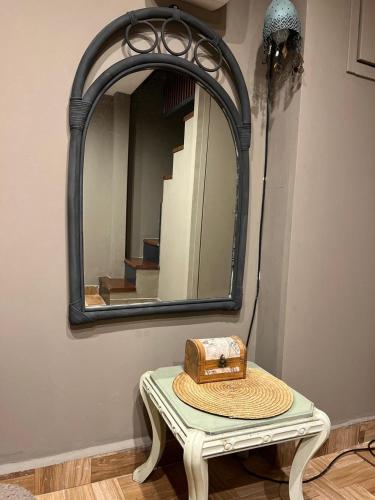 a hat sitting on a table in front of a mirror at Smart Home in Thessaloniki