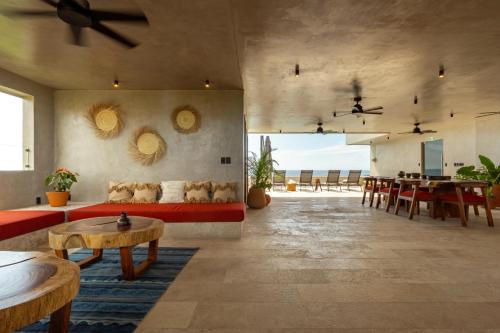 a living room with a red couch and a table at La Olita in Puerto Escondido