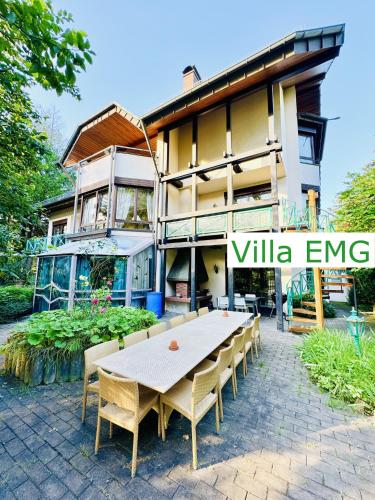 a table and chairs in front of a building at Luxury Spa Villa EMG Karlsruhe Baden-Baden Rastatt - Gernsbach in Gernsbach