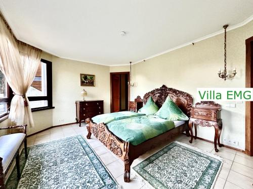 a bedroom with a bed and a couch in it at Luxury Spa Villa EMG Karlsruhe Baden-Baden Rastatt - Gernsbach in Gernsbach