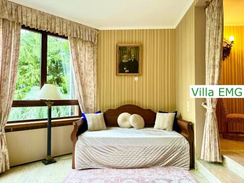 a bedroom with a bed and a window at Luxury Spa Villa EMG Karlsruhe Baden-Baden Rastatt - Gernsbach in Gernsbach
