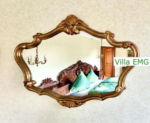 a mirror hanging on a wall with a bed at Luxury Spa Villa EMG Karlsruhe Baden-Baden Rastatt - Gernsbach in Gernsbach