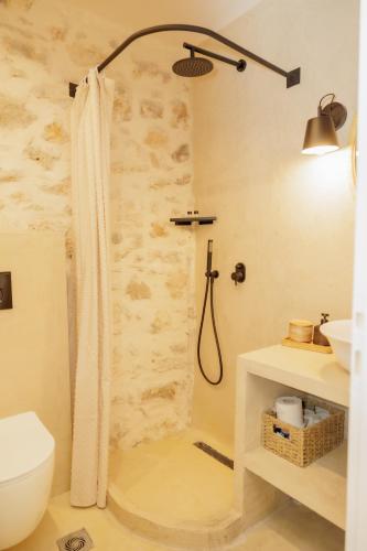 a bathroom with a shower with a toilet and a sink at Caeli's Home in Gythio