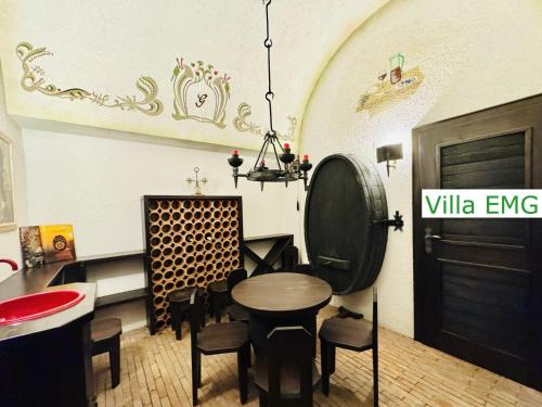 a room with a table and chairs and a black door at Luxury Spa Villa EMG Karlsruhe Baden-Baden Rastatt - Gernsbach in Gernsbach